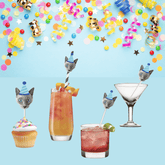 a grey cat wearing a striped blue party hat stuck on various straws and drink stirrers